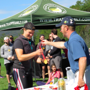 Trapp runner receiving a participation medal after the race.