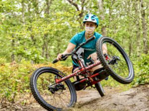 Female athletes is riding her adaptive mountain bike