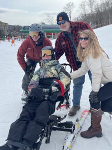Jack and his family after a successful morning of skiing in the TetraSki at Stowe with a joystick.