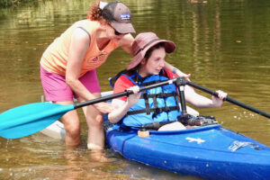 Growing confidence in the kayak with the support of volunteers.