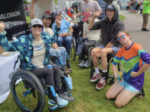 A group of friends hang out after the adaptive bike race.