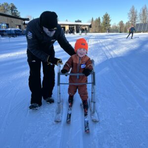 A young cross country skier enjoys using the ski slider.