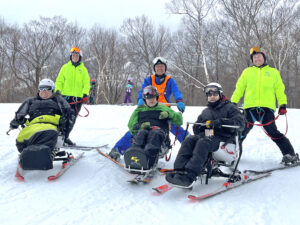 A group of adaptive skiers and their instructors.